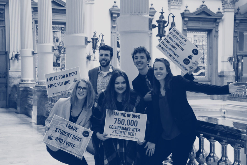 Group poses with photo petitions in support of action on student debt