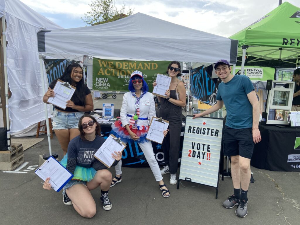 Photo of New Era members registering voters.
