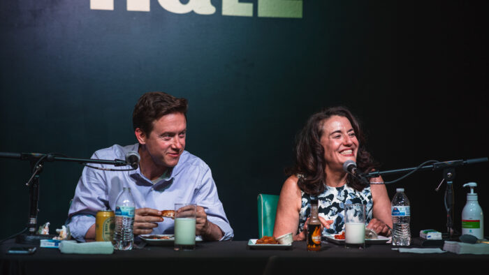 Mike Johnston and Kelly Brough, runoff candidates for Denver mayor, smile in between bites of spicy chicken wings.
