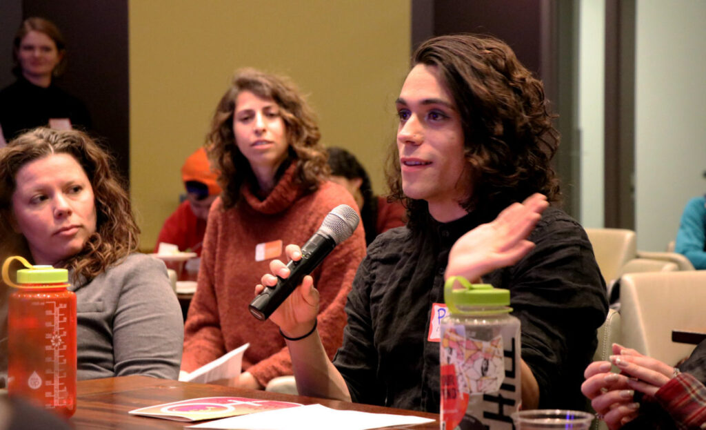 A young woman speaking into a microphone